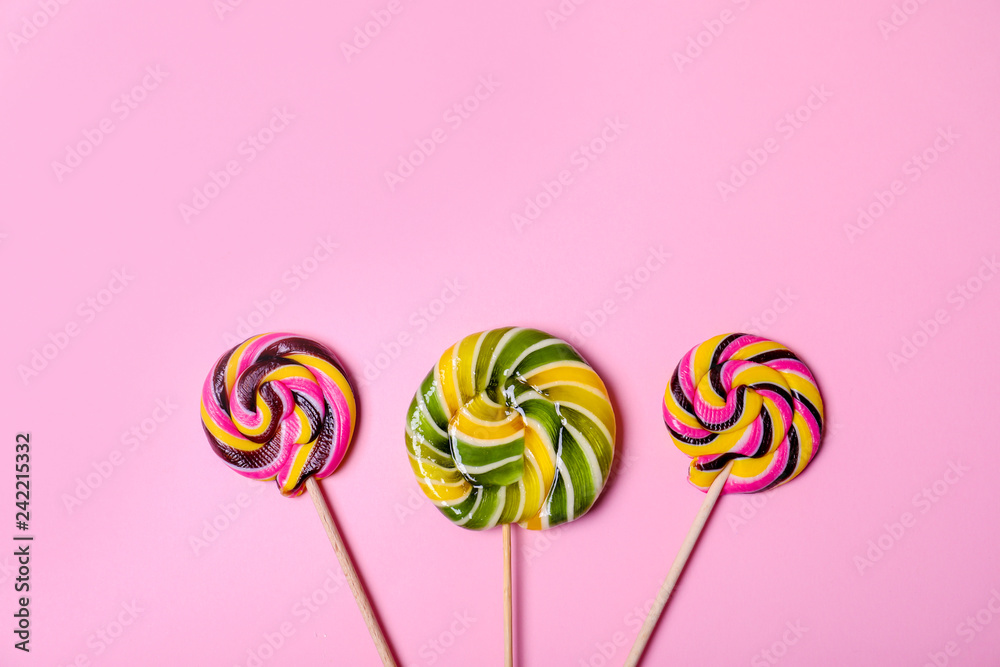 Bright yummy candies on color background, top view Bright yummy candies on color background, top view