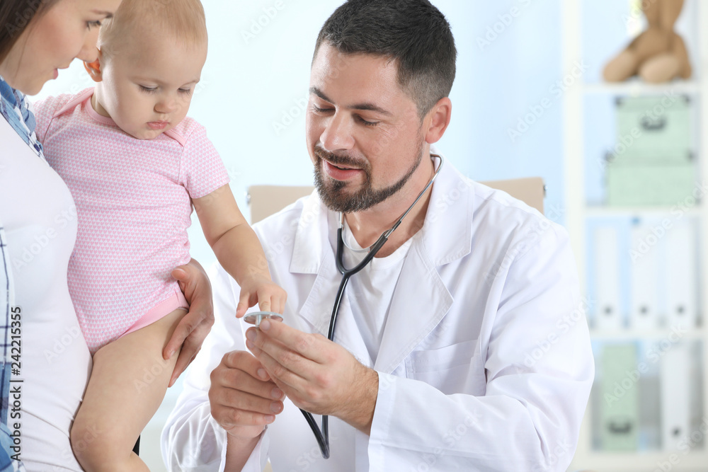 Woman with daughter visiting children's doctor in hospital