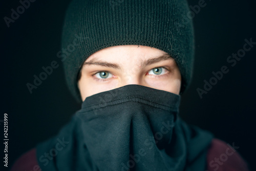 portrait of male bandit wear black bandana gloves and hat isolated on dark background b