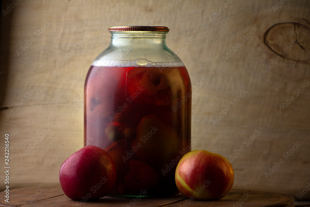 Home-made canned compote and fresh fruit on the basement shelf still life Home-made canned compote and fresh fruit on the basement shelf still life