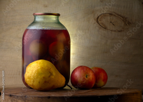 Home-made canned compote and fresh fruit on the basement shelf still life