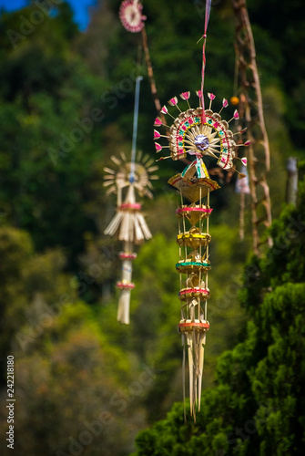 Beautiful Decorative Balinese Penjor. Penjor are tall tapered poles made from bamboo and placed outside Balinese Hindu homes during certain religious holidays such as Galungan and Kuningan. photo