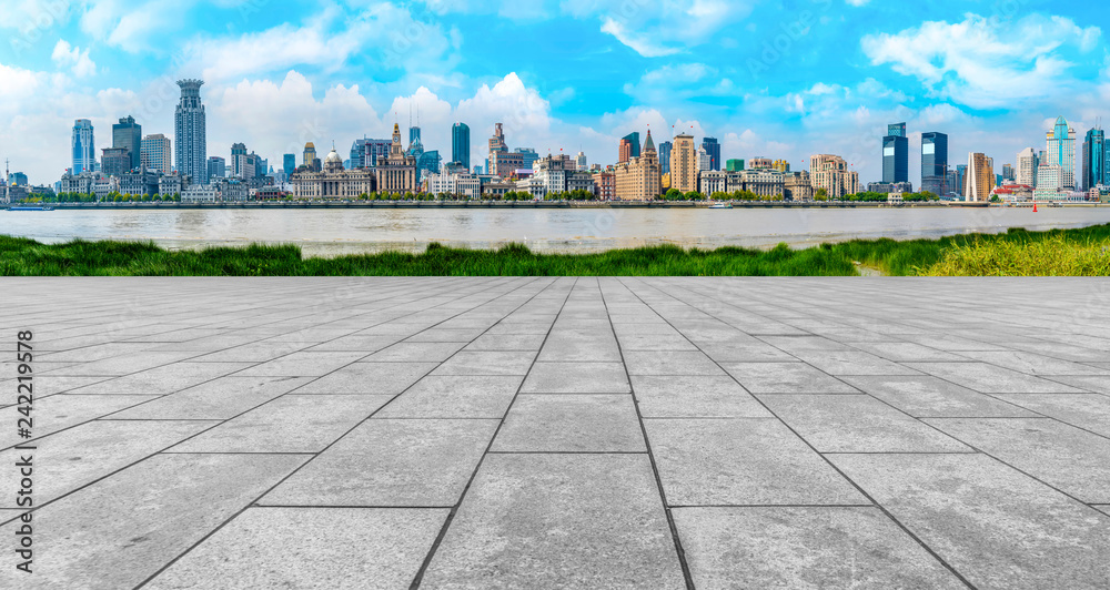 Empty marble floors and city views under the blue sky Empty marble floors and city views under the blue sky