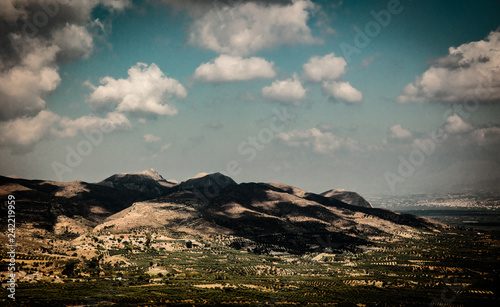 Olive gardens and mountains in central province of Heraclio, Crete, Greece. Summertime season, July photo