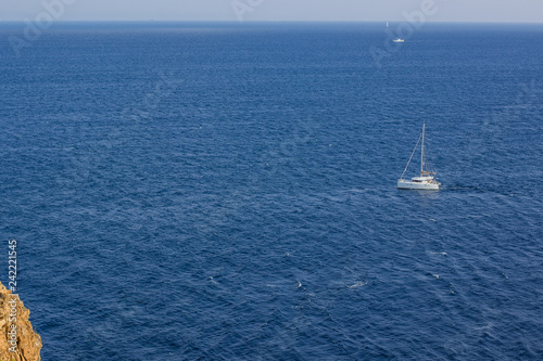 aerial landscape photography beautiful picturesque Mediterranean scenic landscape of white expensive cruise yacht on sea vivid blue water surface with view on horizon board with sky, copy space © Артём Князь