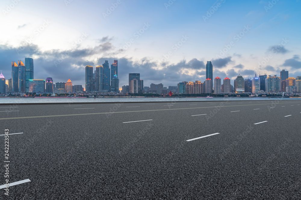 Empty asphalt road along modern commercial buildings in China,s cities Empty asphalt road along modern commercial buildings in China,s cities