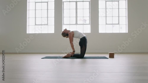 healthy yoga woman practicing camel pose enjoying fitness lifestyle exercising in studio stretching flexible body training early photo