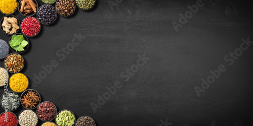 Fototapeta Naklejka Na Ścianę i Meble -  collection Indian spices and herbs on  blackboard. colorful seasonings on  black table, top view. condiments with space for recipe or label