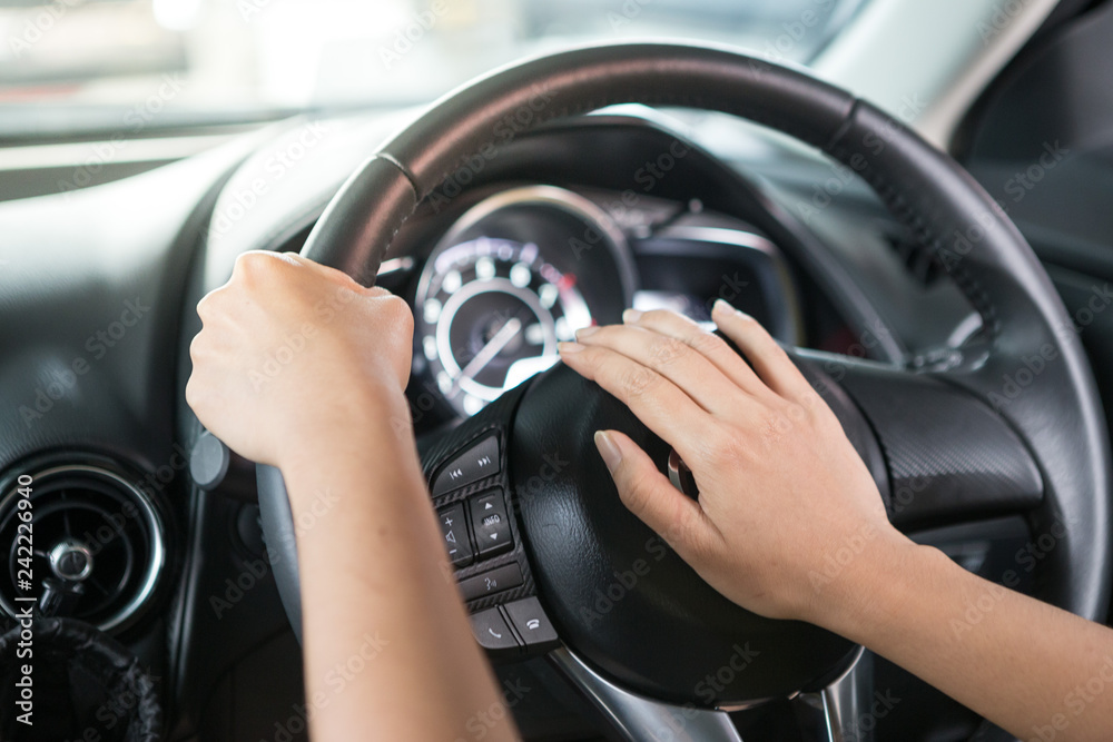 Woman hand holding steering horn