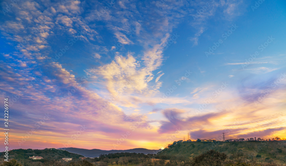 Sunset landscape, blue, purple, gold sky with clouds, wine country California, Napa valley scenery