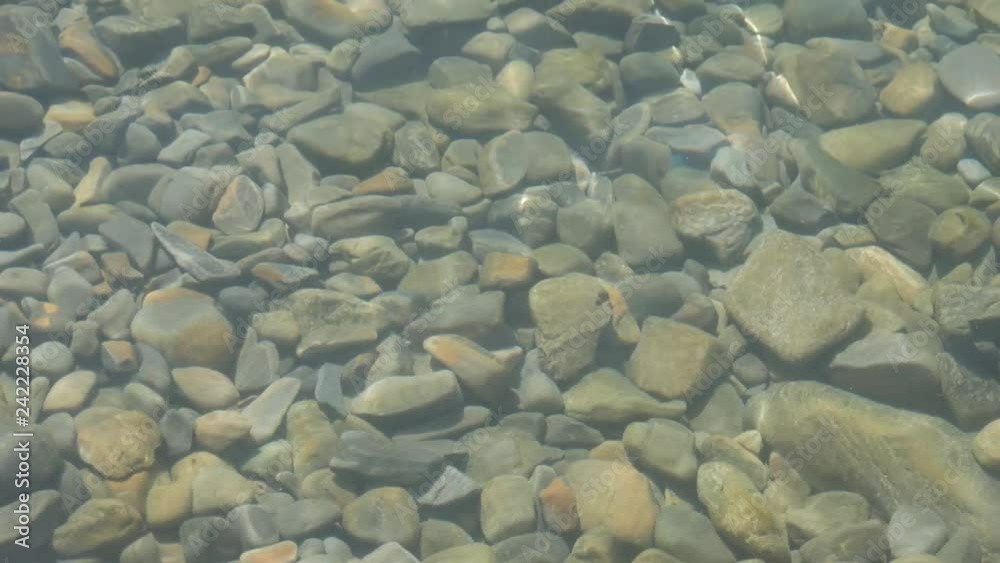 Front view of sea waves breaking on rocks. Rock with the big stones in the sea and waves with foam. Front view of sea waves breaking on rocks. Rock with the big stones in the sea and waves with foam.