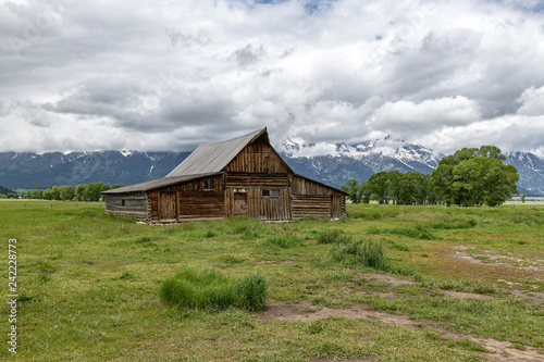 Old mormon barn in Grand Teton Mountains with low clouds. Grand Teton National Park, Wyoming, USA. © jgorzynik