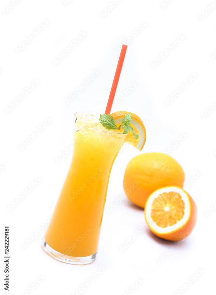 Orange juice from natural citrus fruit in a clear glass on a white background.soft focus. Orange juice from natural citrus fruit in a clear glass on a white background.soft focus.