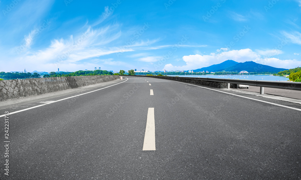 Empty asphalt road square and natural landscape under the blue sky