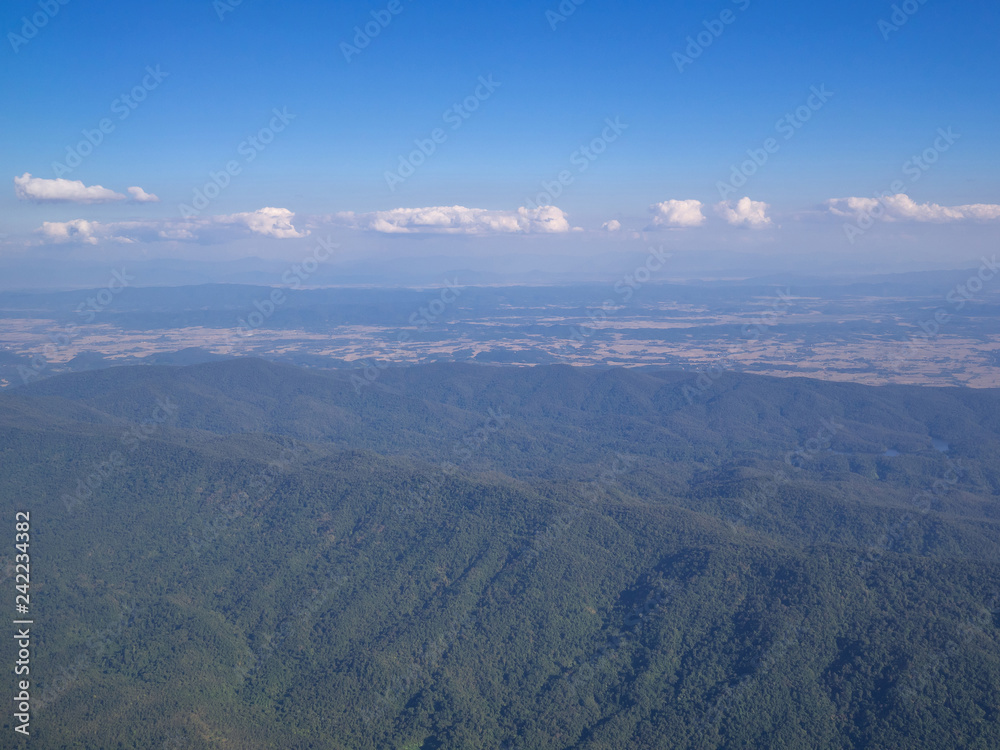 Beautiful landscape with mountains covered with green forest. Bird's-eye view.