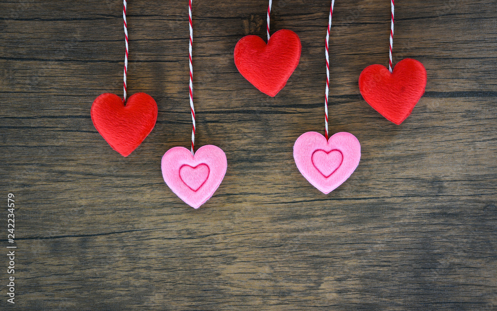 Valentines day love heart concept Hanging red and pink heart decorate on wooden rustic texture