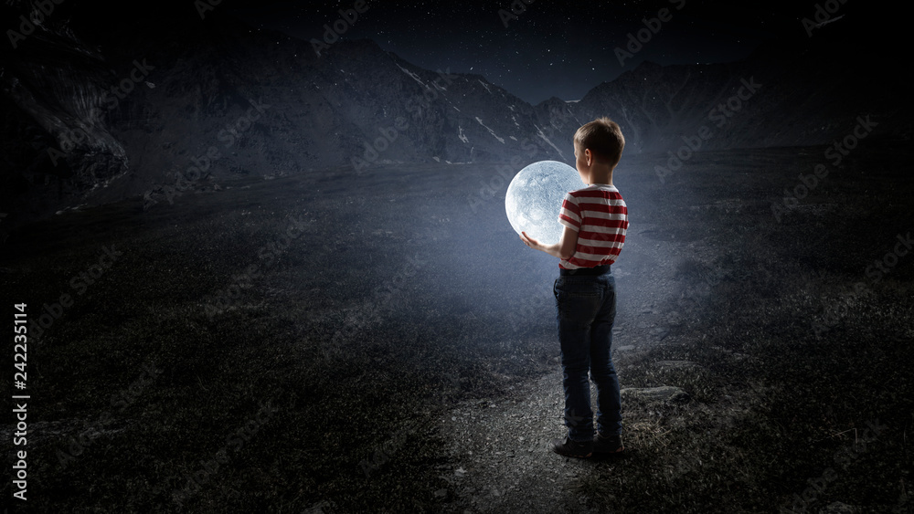 Fototapeta premium Boy holds the moon . Mixed media