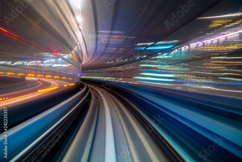 Motion blur of a city and tunnel from inside a moving monorail in Tokyo