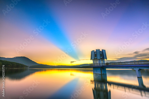 Architectural beauty hydroelectric power with long rays sunset sky radiating beautifully colorful atmosphere as warm to admire