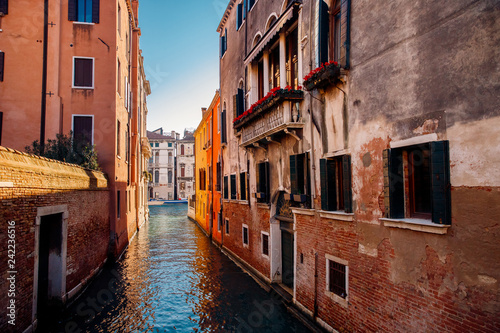 Small canals boats, old brick houses Venetian style Venice, Italy.