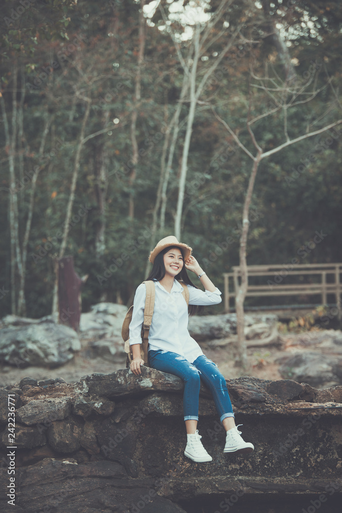 Asian girl backpack. Traveler woman with backpack walk alone on path tree. Relax time on holiday concept travel Asian girl backpack. Traveler woman with backpack walk alone on path tree. Relax time on holiday concept travel