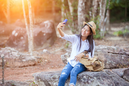 Young woman selfie on the beautiful nature view. Asian girl backpack. Relax time on holiday concept travel
