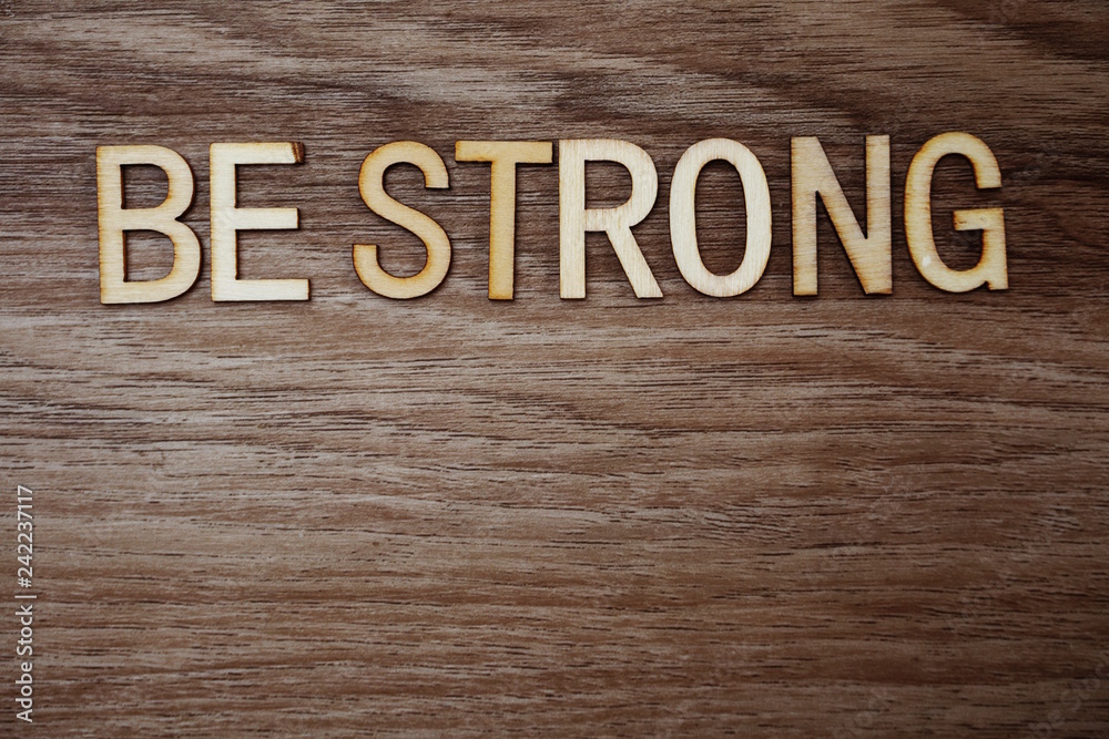 Be Strong alphabet letters on wooden background business concept Be Strong alphabet letters on wooden background business concept