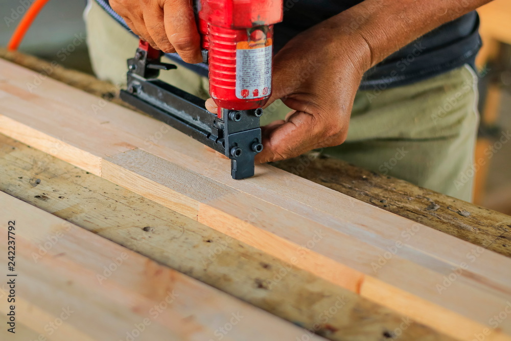Carpenters are using tools with wood working furniture.