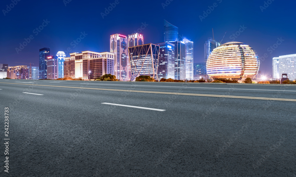 Obraz premium Road Pavement and Night View of Hangzhou Urban Architecture..