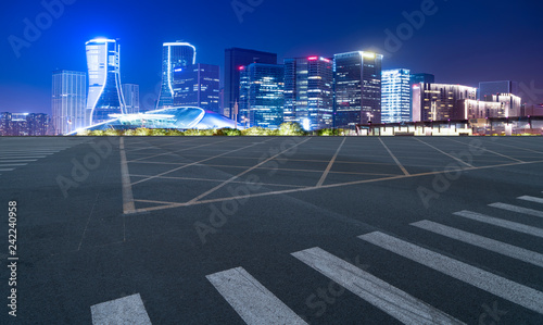 Fototapeta Naklejka Na Ścianę i Meble -  Road Pavement and Night View of Hangzhou Urban Architecture..