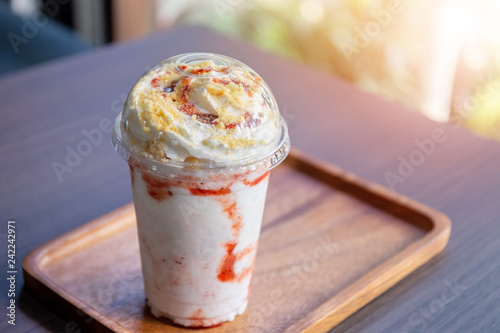 Close up Strawberry cheesecake frappuccino on wooden plate with copyspace in coffee shop