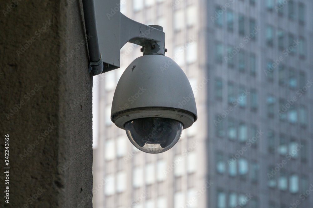 Surveillance Security Camera in the Big City with buildings and windows in the background Surveillance Security Camera in the Big City with buildings and windows in the background