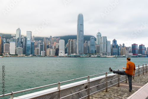 A man exercising in front of Hong Kong Victoria Harbour