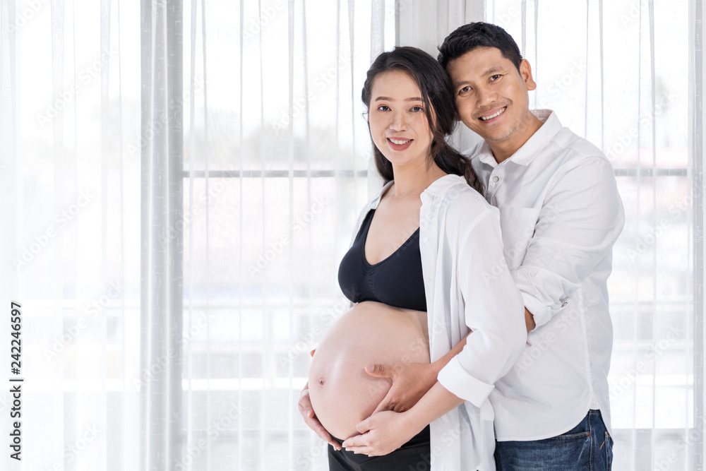 pregnant woman with husband with window background pregnant woman with husband with window background