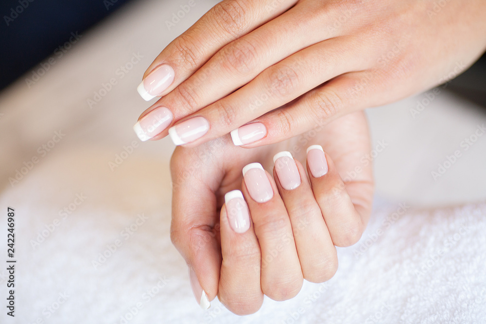 Manicure. Skillful master of manicure holding file in her hands while working in her beauty salon