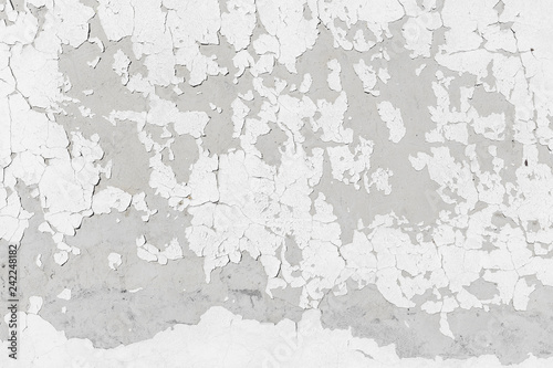 Concrete wall texture background with grey grungy stucco, white peeled paint, cracks and stains