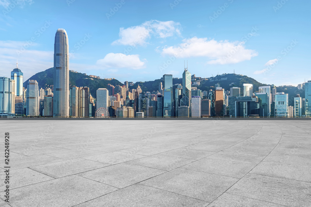 Empty marble floors and city views under the blue sky Empty marble floors and city views under the blue sky