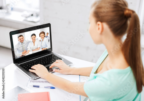 business  education and technology concept - woman or student having video interview with employer or teacher team on laptop computer at home or office