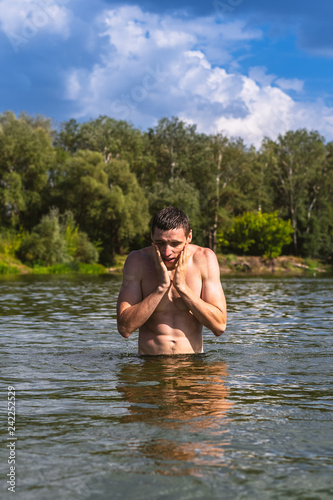 Portrait of a handsome young man in the water.