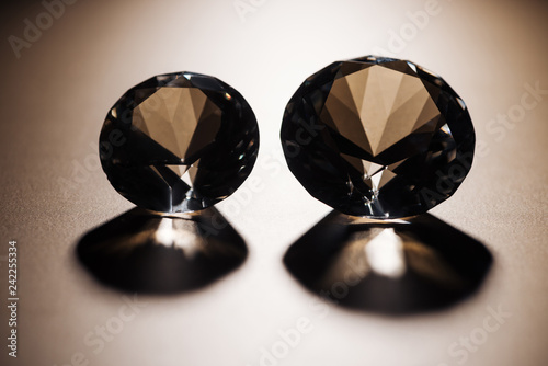 clear big diamonds with shadows on beige background photo