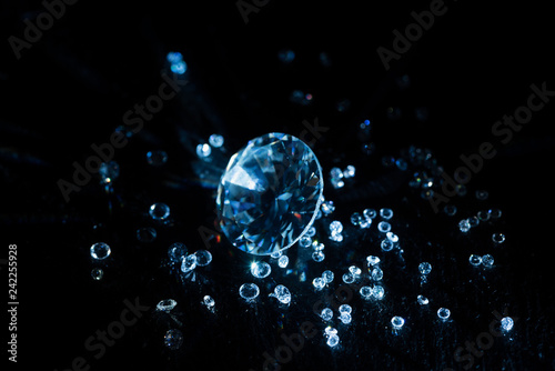 big and small transparent clear diamonds isolated on black