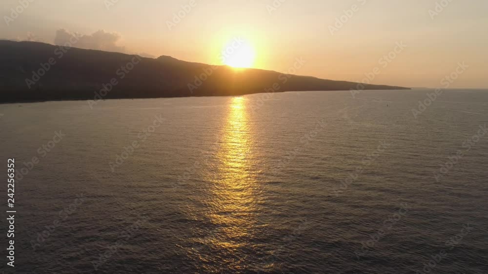 aerial view bright sun reflected from water surface. sun track on sea water. Flying over surface sea at sunset. aerial seascape ocean surface. Travel concept