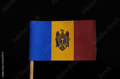 A official and unique flag of Moldavia on toothpick on black background. A three vertical colours blue, yellow and red. In yellow in center there is coat of arm of Moldavia photo