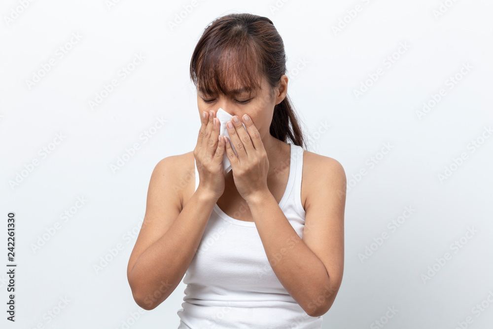 Young woman sick having allergy and sneezing in tissue isolated on a white background Young woman sick having allergy and sneezing in tissue isolated on a white background