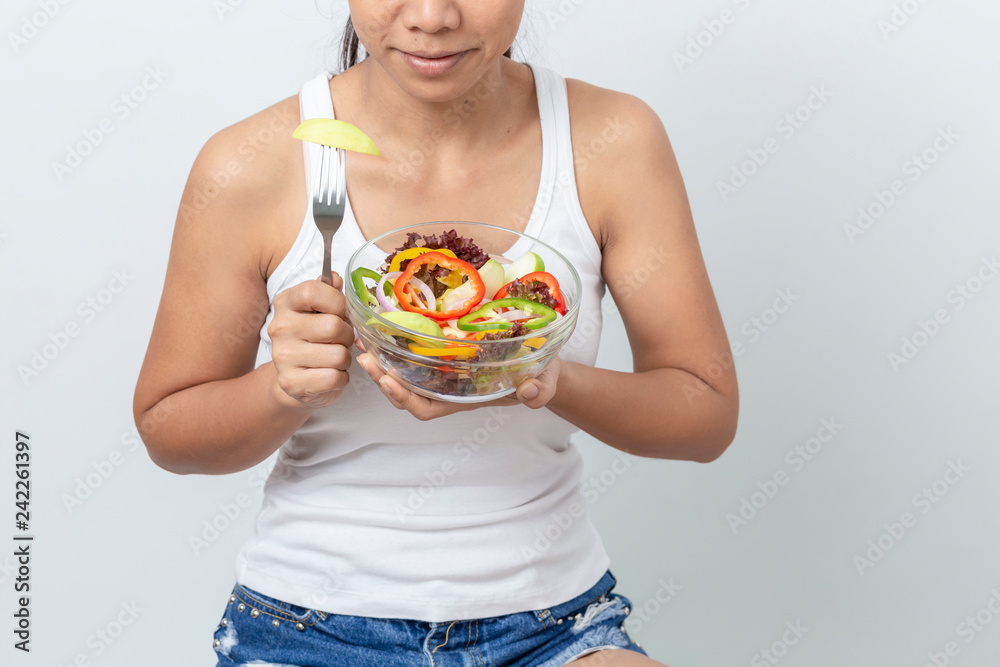 Portrait of beautiful asian young woman eating vegetable salad Isolated on white background. Portrait of beautiful asian young woman eating vegetable salad Isolated on white background.