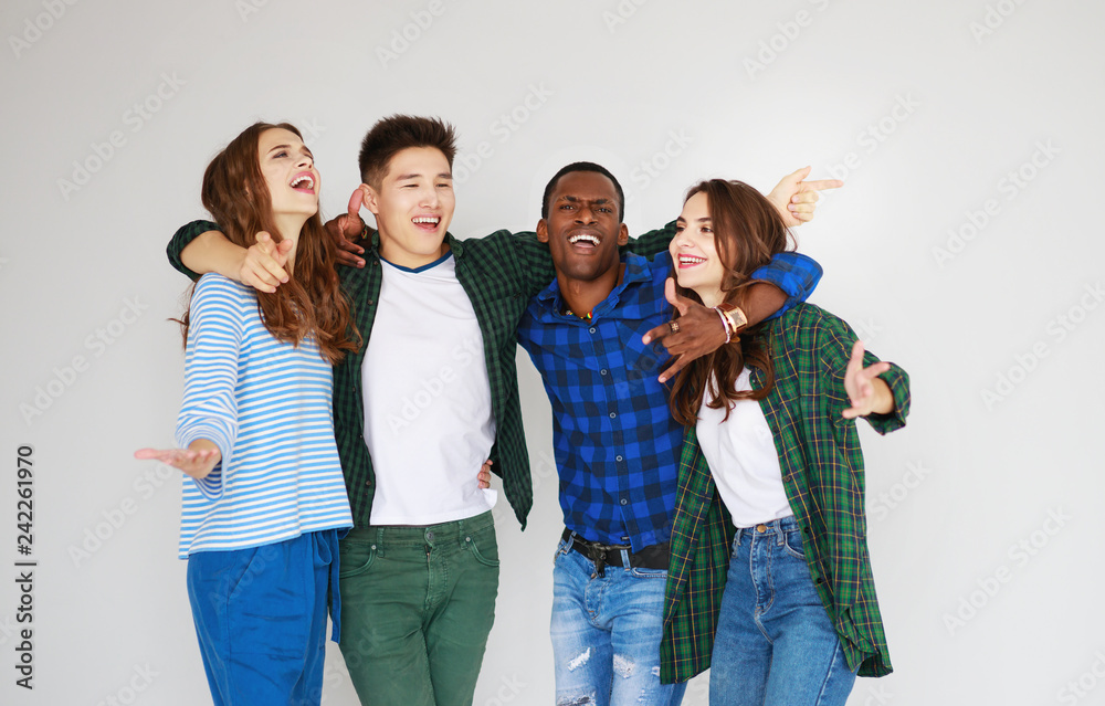 Obraz premium group of cheerful young people men and women isolated on white background.