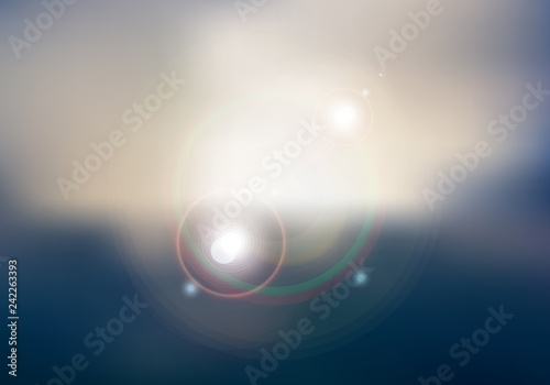 Abstract sunset or sunrise sky and sun shining blurred background with flare. © rarinlada