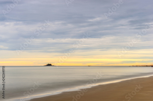 Calm sea and colorful sky during sunrise. Bright seascape background.