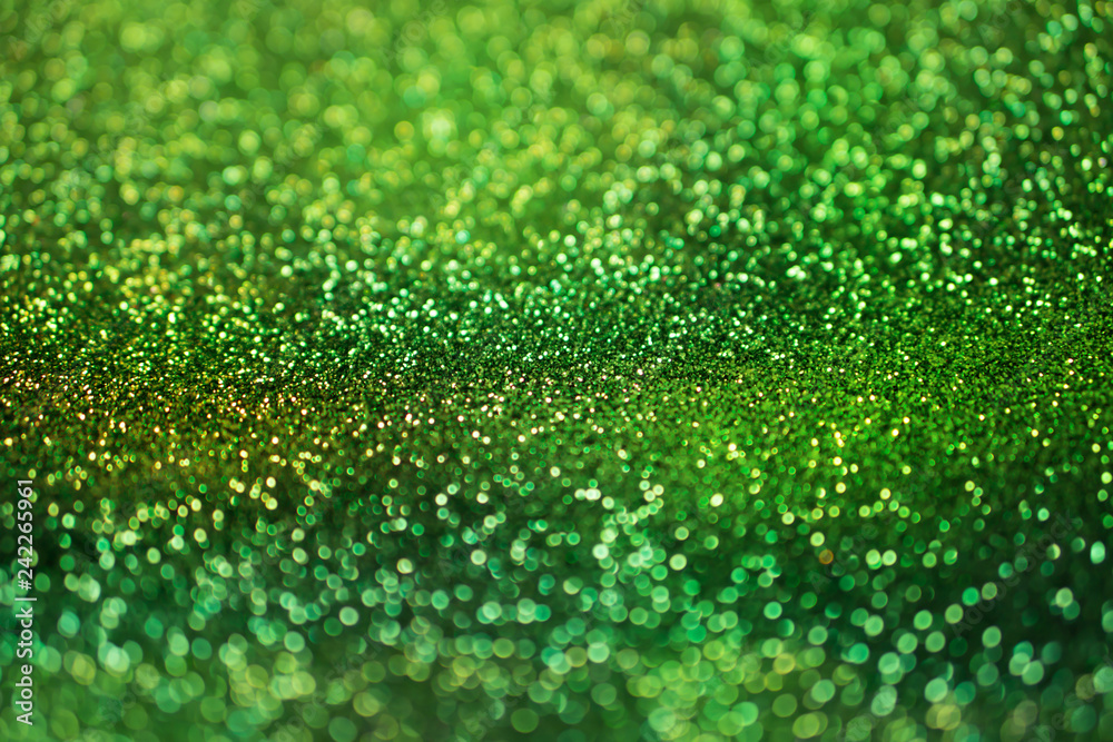 colorful glowing green glitters texture background for decorative concept 
