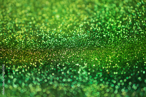 colorful glowing green glitters texture background for decorative concept 